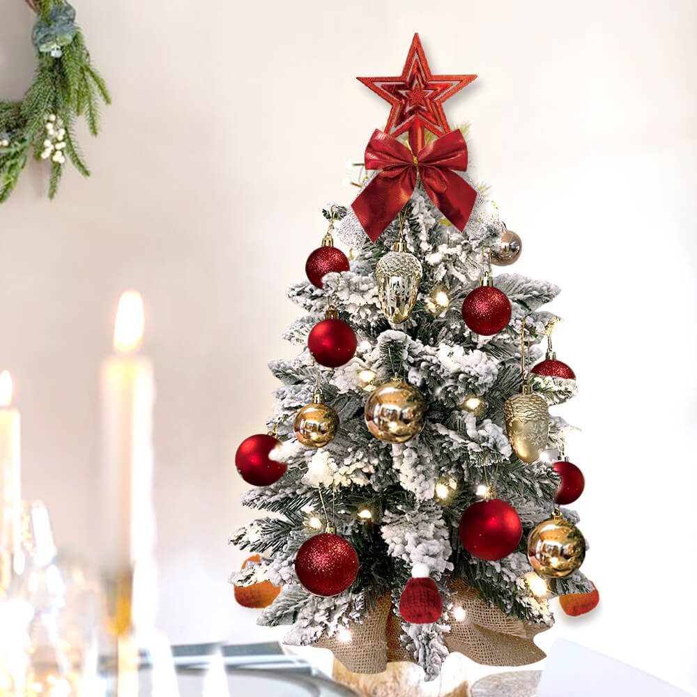Decorated Christmas tree with red and gold ornaments on a white background