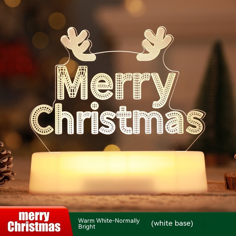 Decorative light sign with 'Merry Christmas' text on a wooden base, blurred Christmas tree and lights in the background.